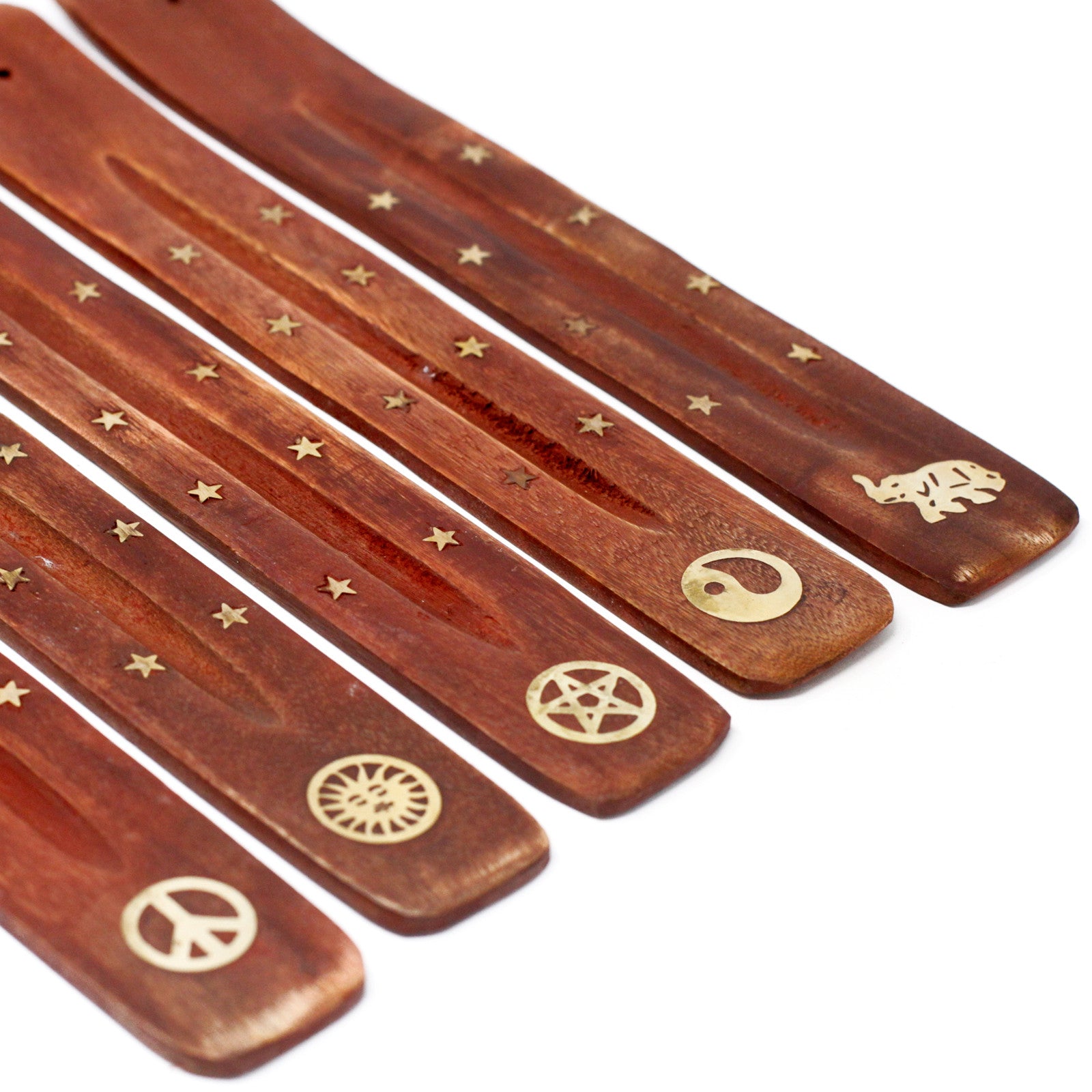 Set of wooden incense sticks with gold symbols on a white background