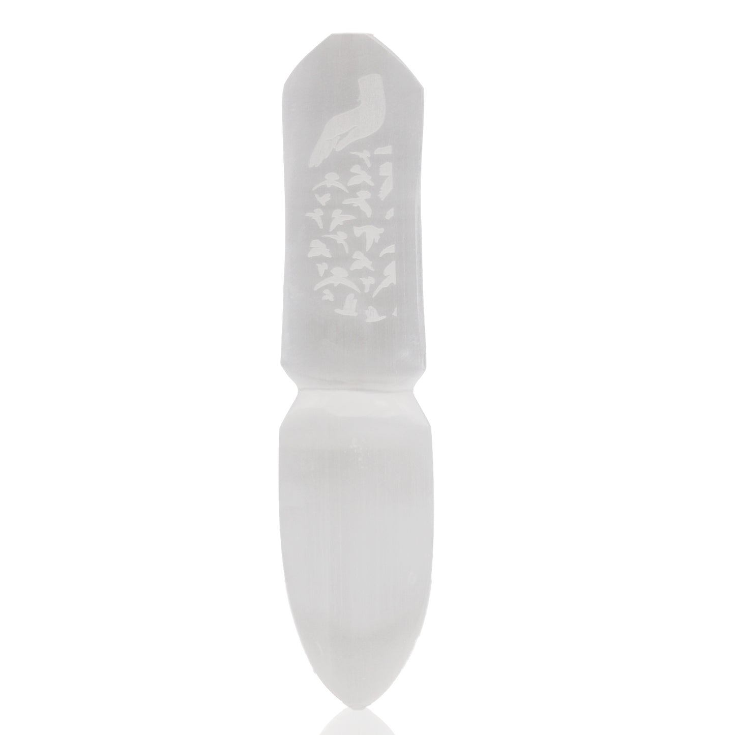 White stone tool with engraved design on a white background