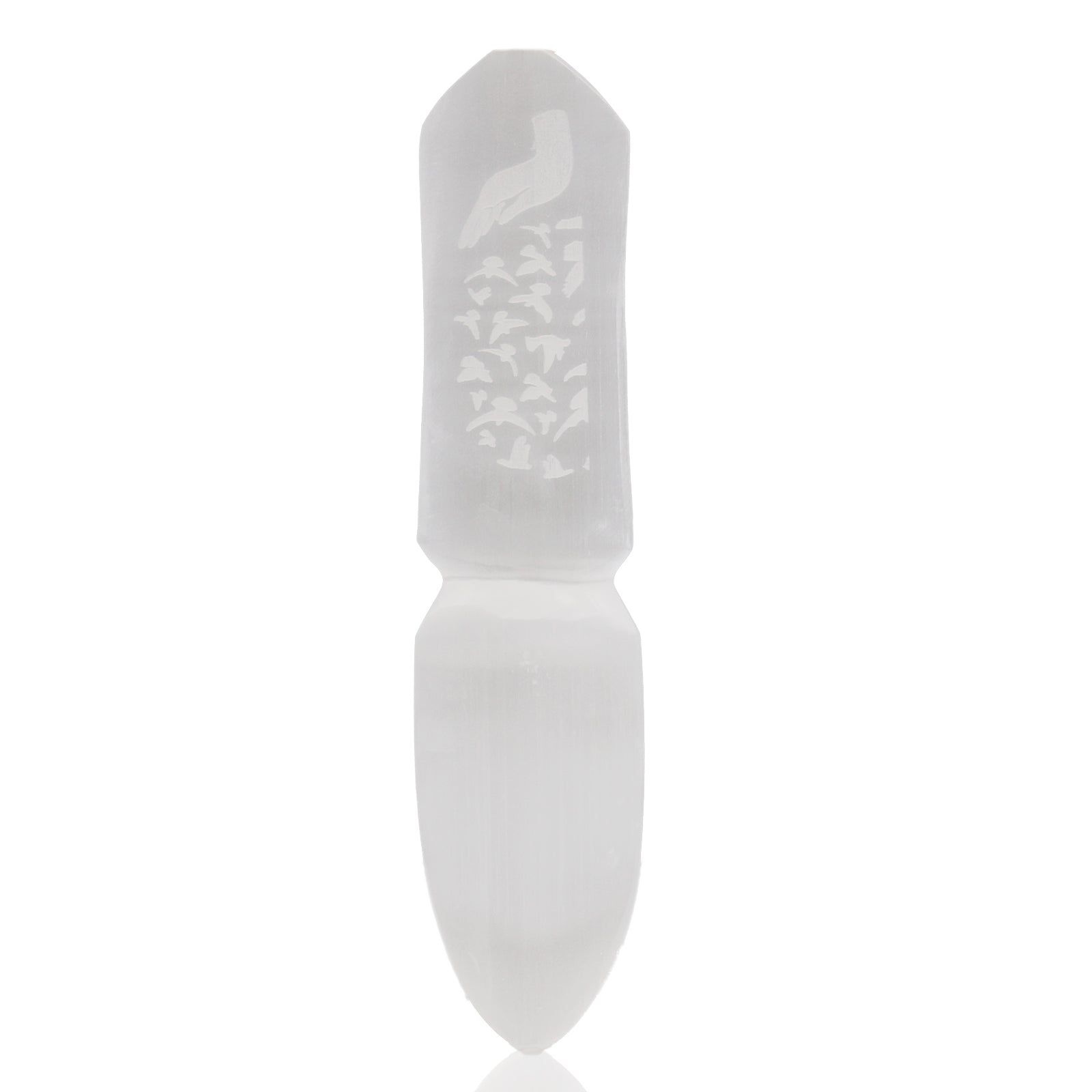 White stone tool with engraved design on a white background