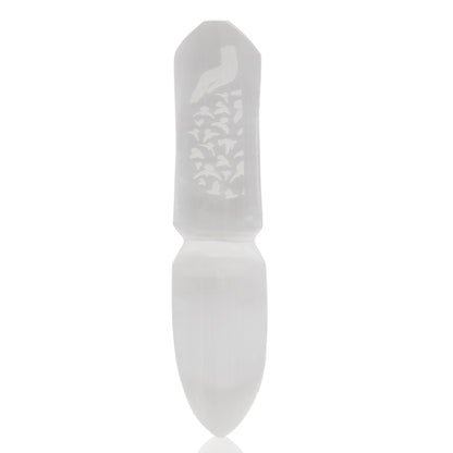 White stone tool with engraved design on a white background