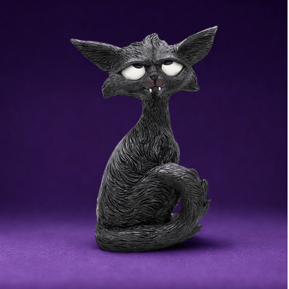 Black cat humorous figurine with white eyes looking up and little white fangs  on a purple background