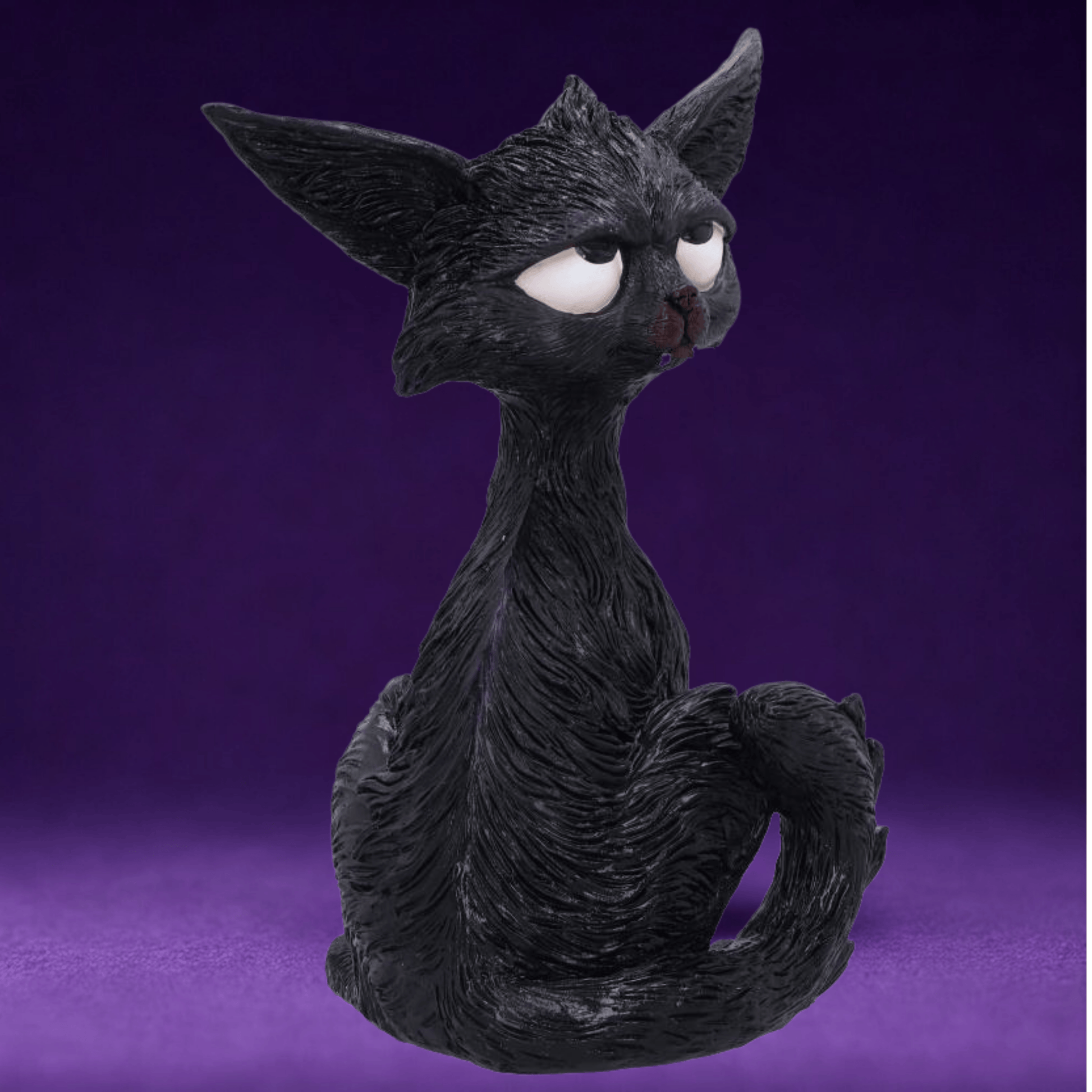 Black cat humorous figurine with white eyes looking up and large ears on a purple background 