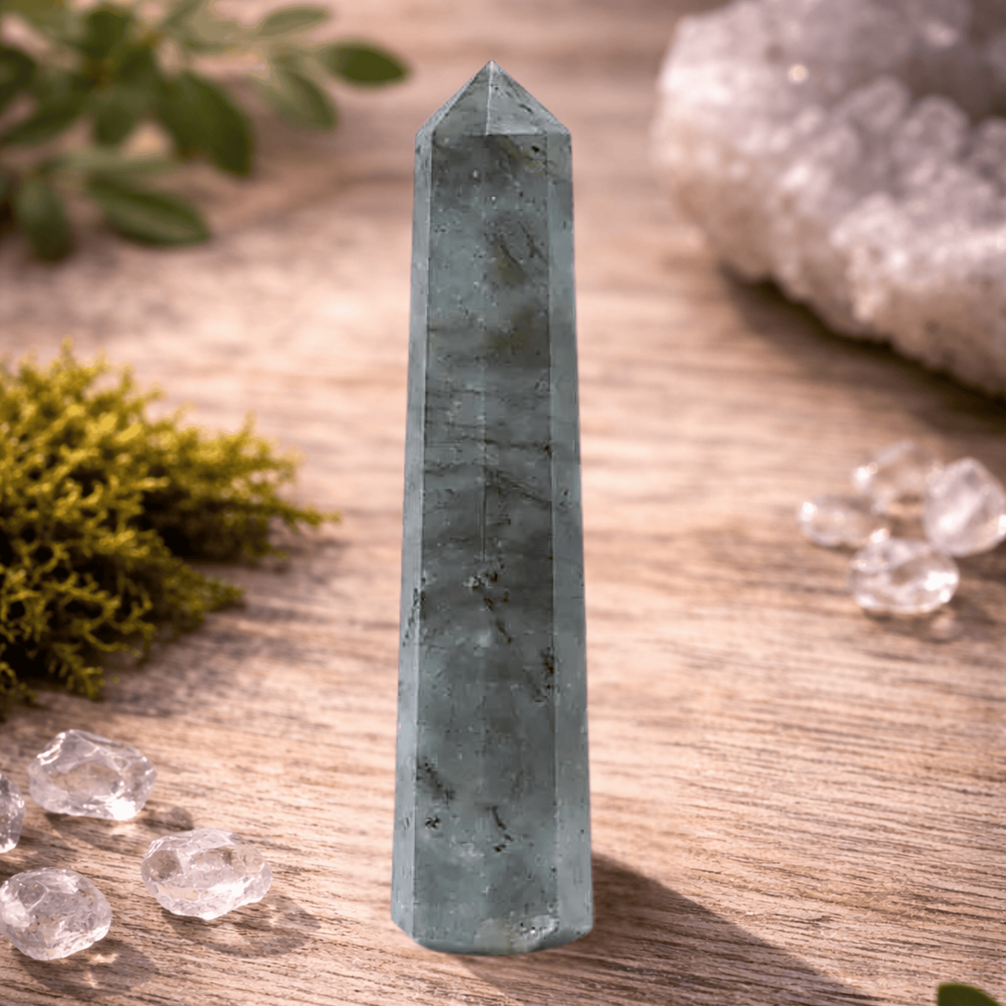 Crystal tower on a wooden surface with crystals and plants around