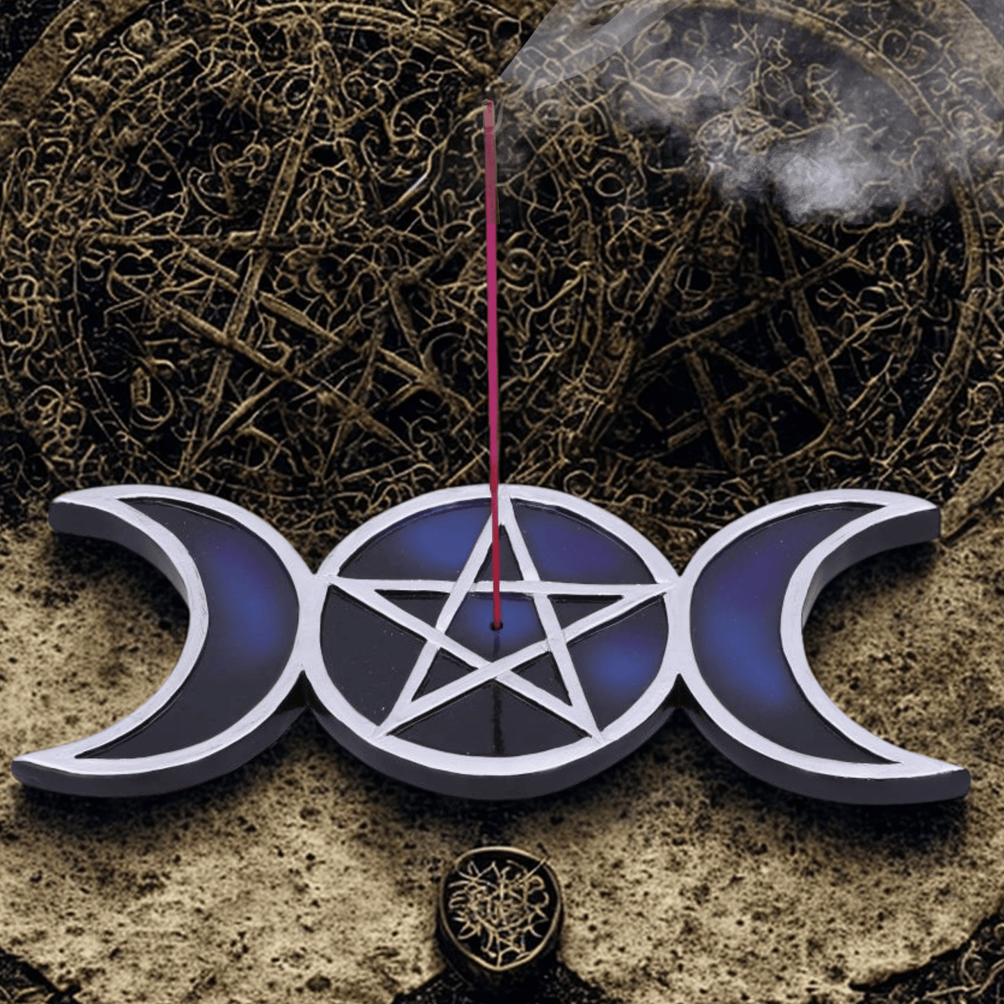 Triple moon symbol with a pentagram in the center resin with silver and blue incense burner with a stick of incense burning on a textured background