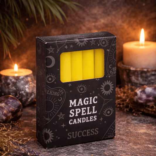 Box of 'Magic Spell Candles' labeled 'Success' with candles and stones in the background.