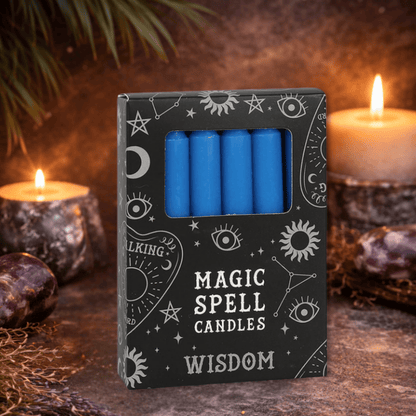 Box of blue spell candles labeled 'Magic Spell Candles Wisdom' with candles and crystals in the background.