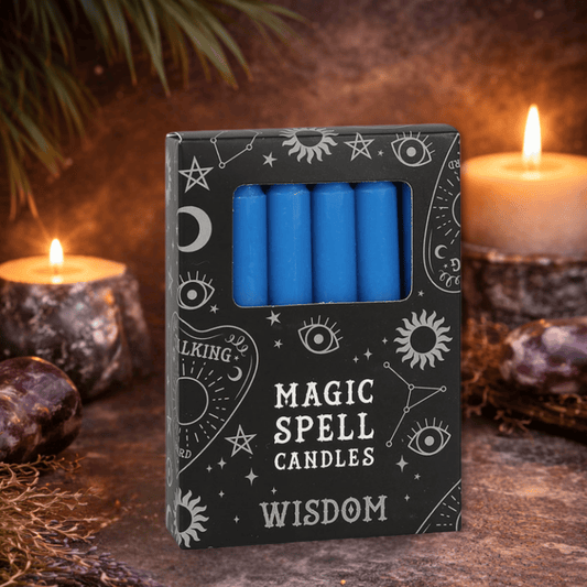 Box of blue spell candles labeled 'Magic Spell Candles Wisdom' with candles and crystals in the background.