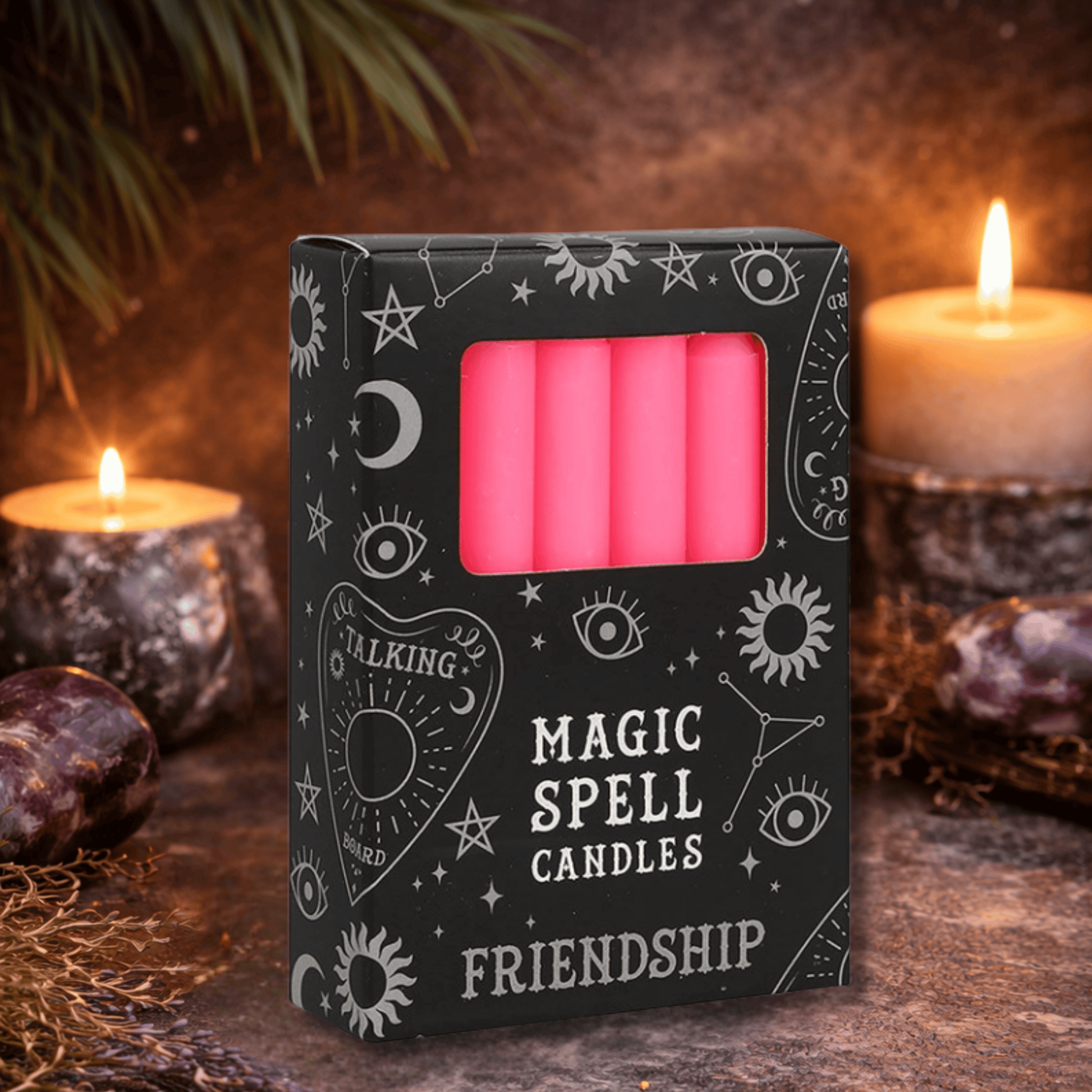 Box of pink 'Magic Spell Candles' with mystical symbols on a dark background