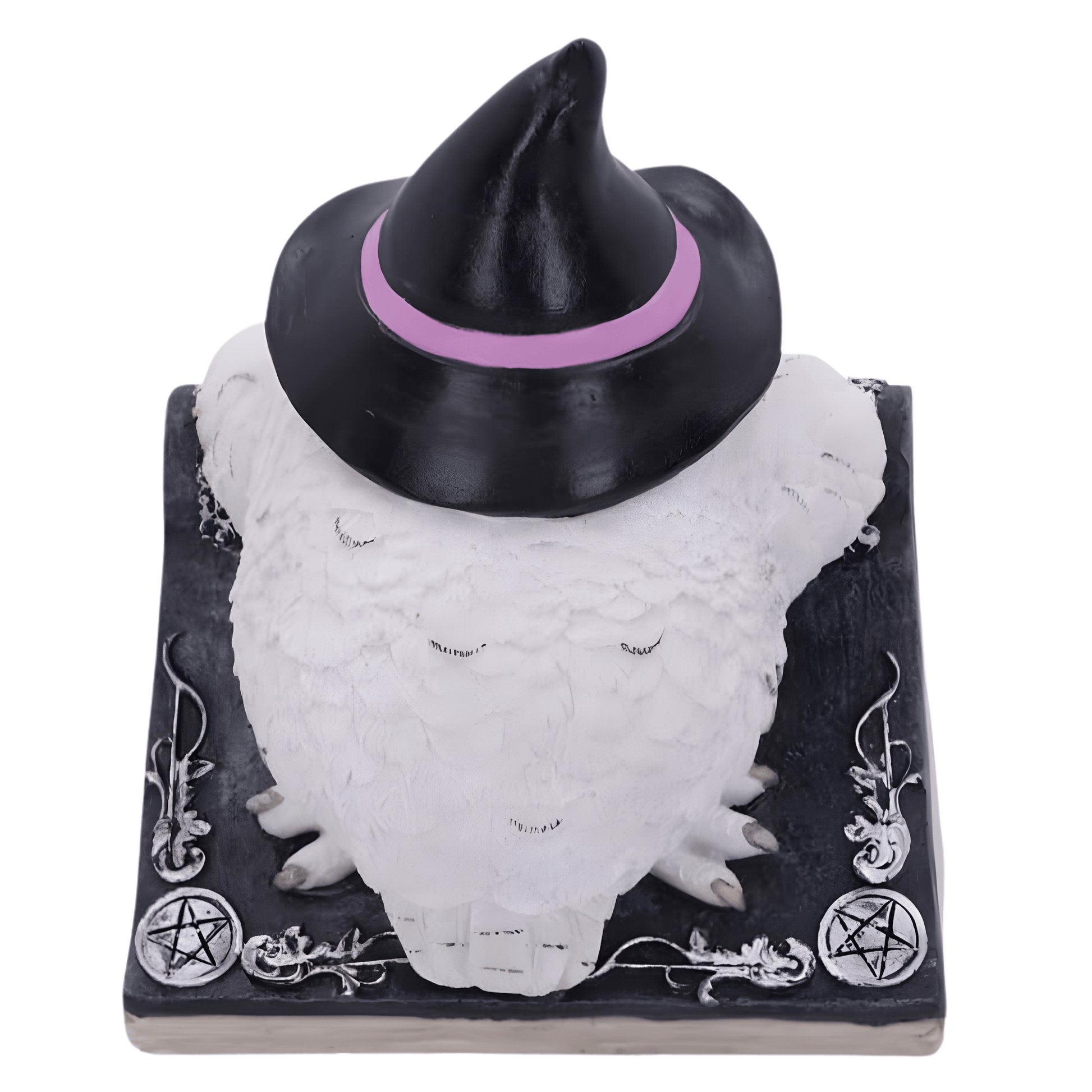 Back of a white owl figurine wearing a black witch hat with a pink band on a black base with white designs.