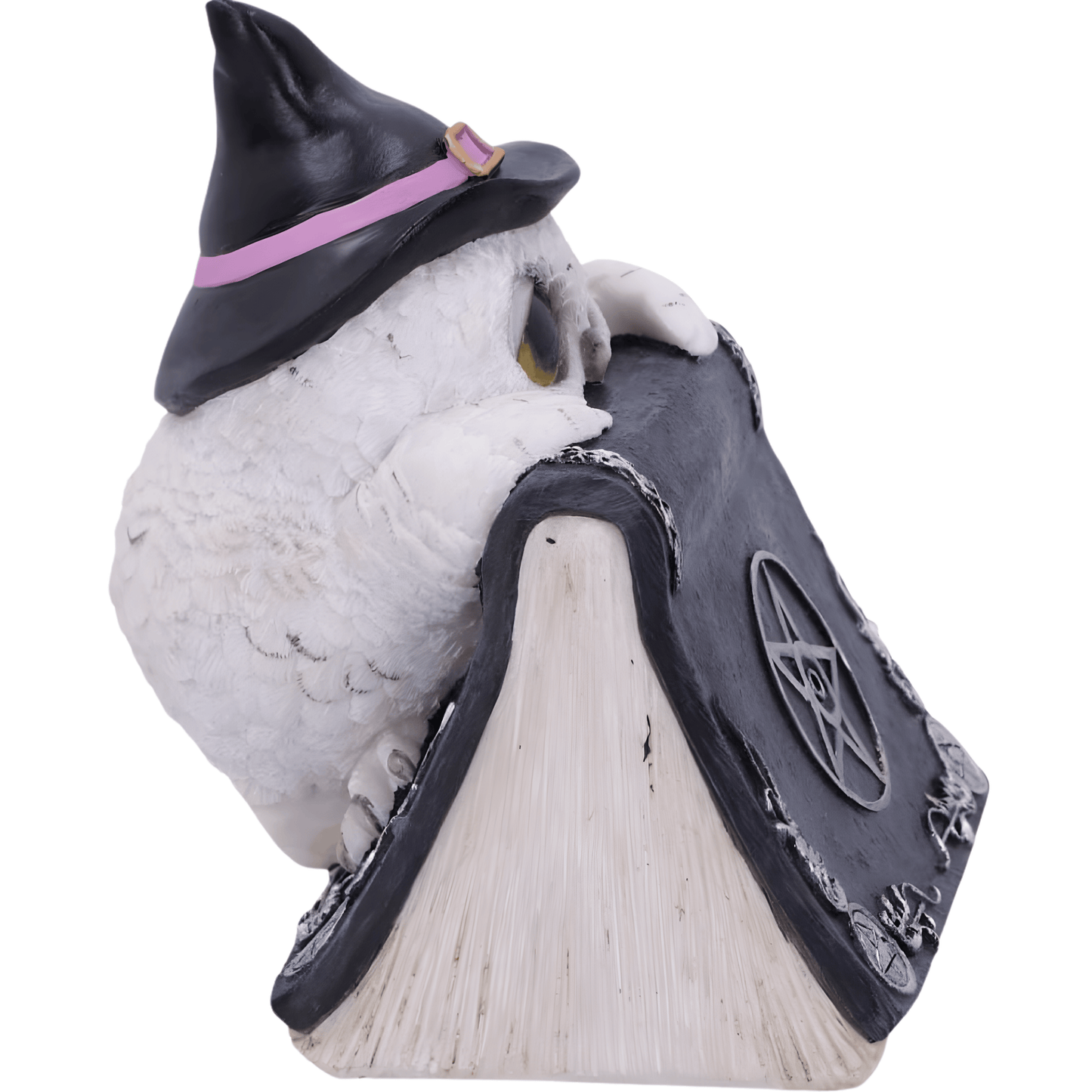 Owl figurine wearing a witch hat on a book with a pentagram symbol