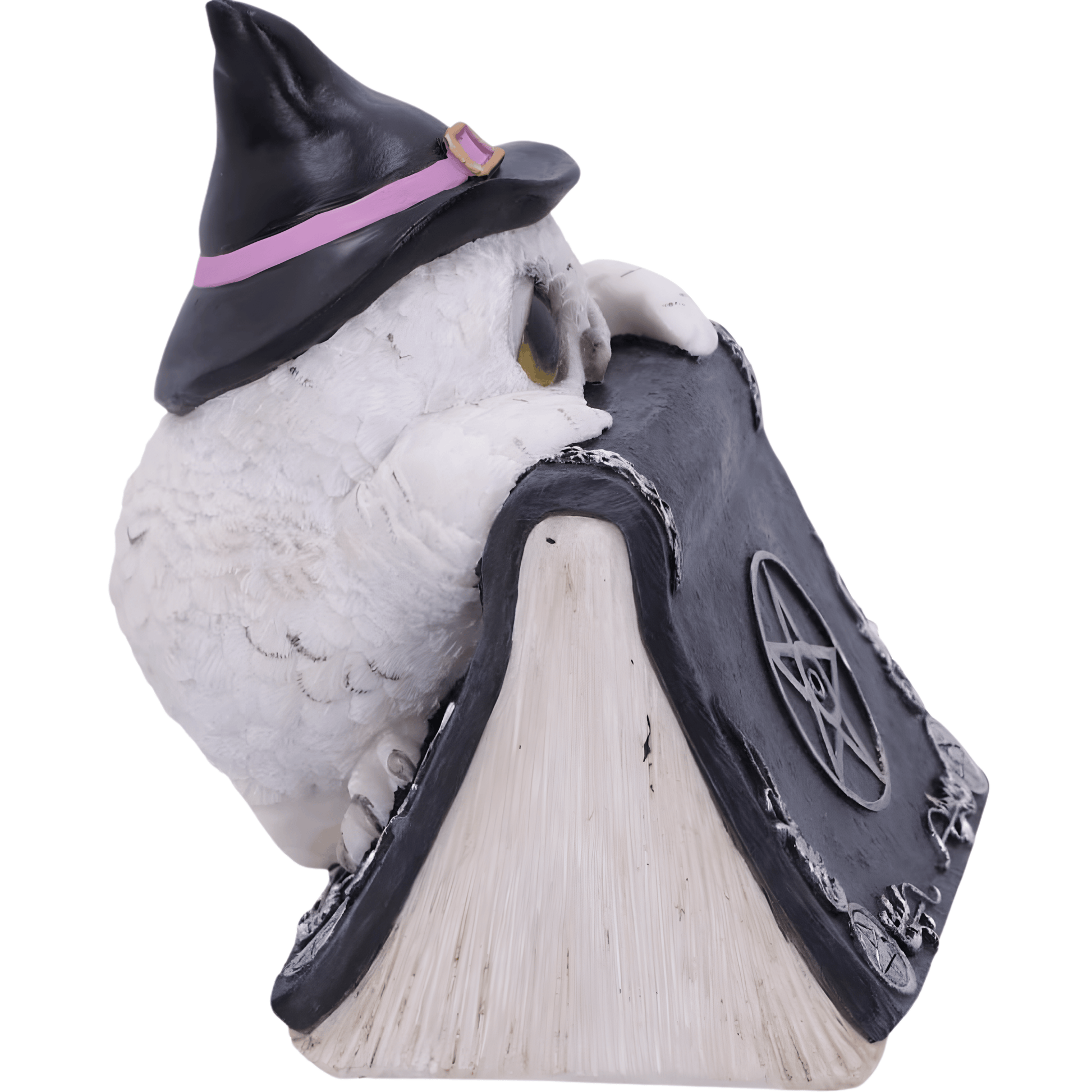Owl figurine wearing a witch hat on a book with a pentagram symbol