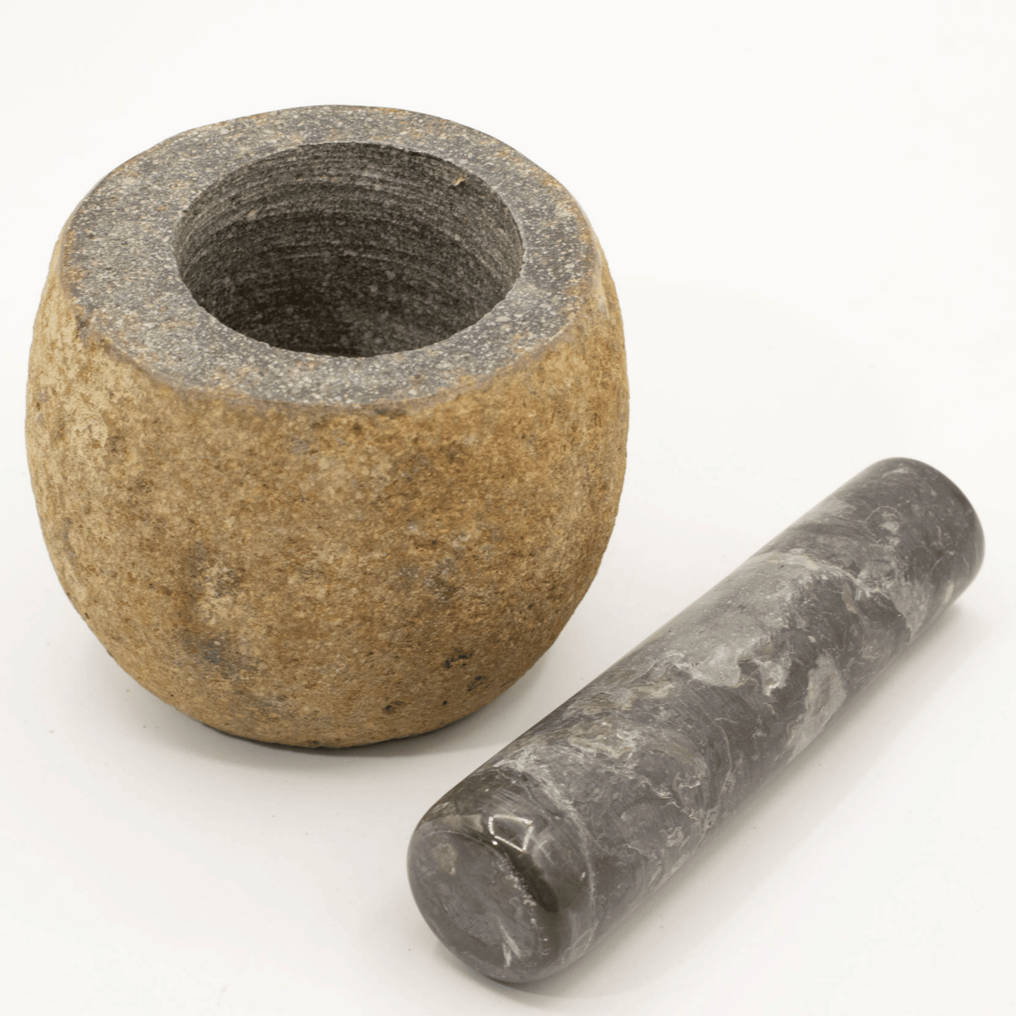 Stone mortar and pestle on a white background