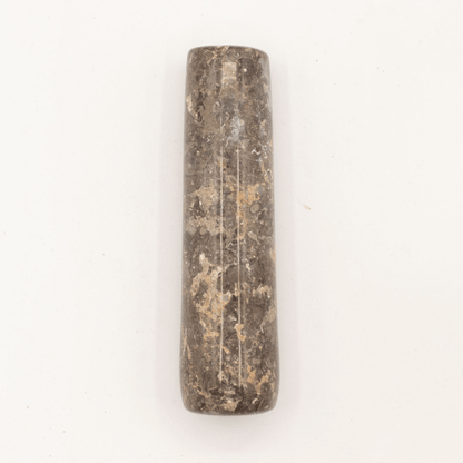 Cylindrical stone object on a white background