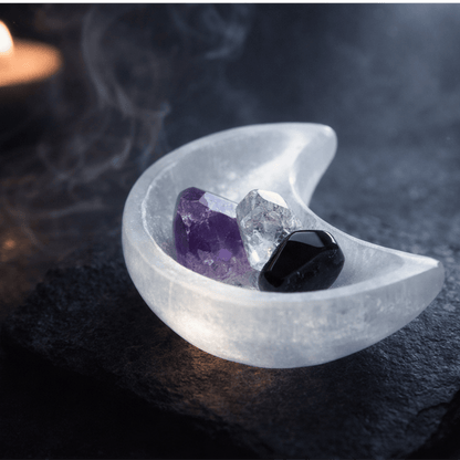 white Crystal shaped as a moon with a purple, white and black crystal in it