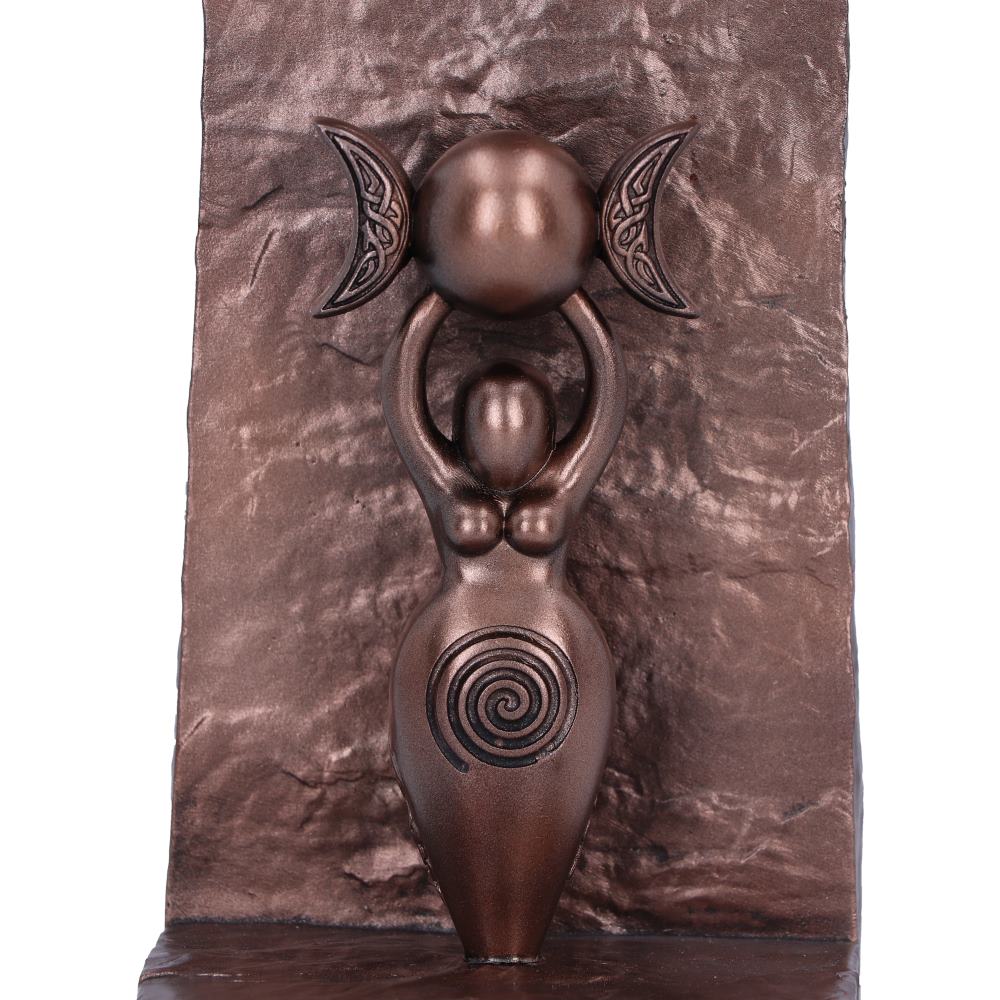 Bronze sculpture of a Goddess holding a triple moon with spiral design on a textured bronze background