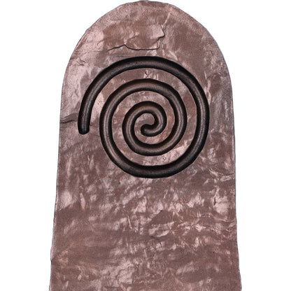 Close up of the Spiral design on the bronze holder on a textured surface