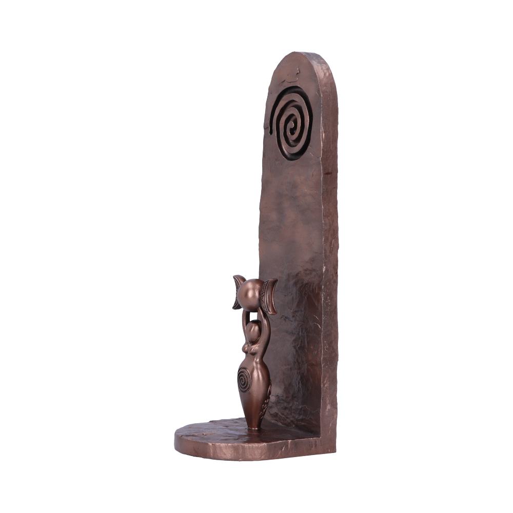 Side of the bronze sculptured incense holder of a Goddess holding a triple moon with spiral design on a textured bronze background