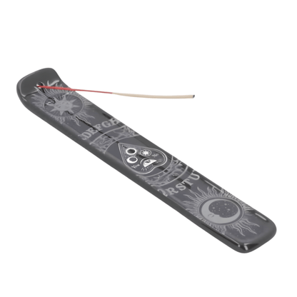 Incense holder with engraved designs on a white background