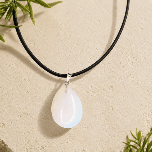 Necklace with a teardrop-shaped pendant on a beige background