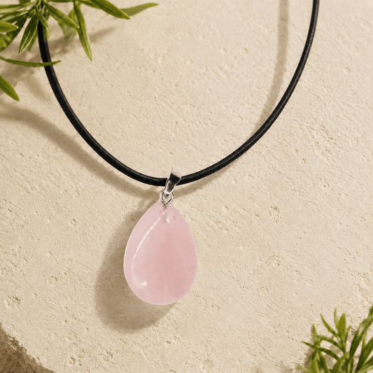 Necklace with a pink teardrop pendant on a beige background