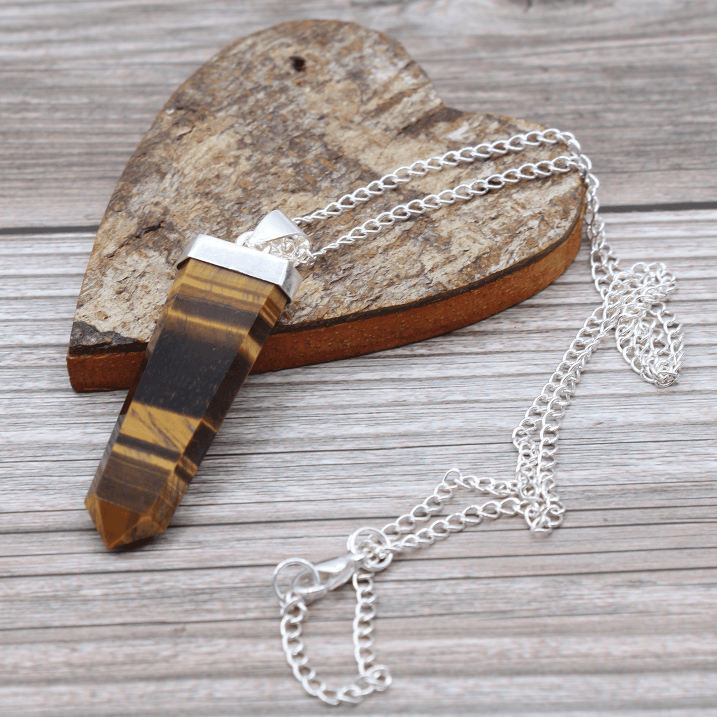 Necklace with a wooden pendant on a wooden surface