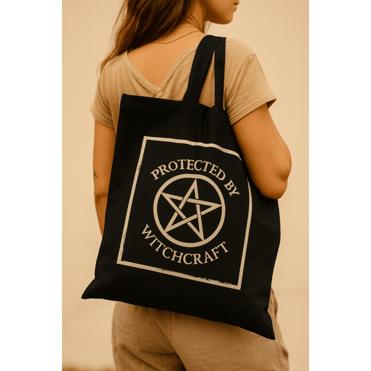 Person wearing a black tote bag with 'Protected by Witchcraft' design.
