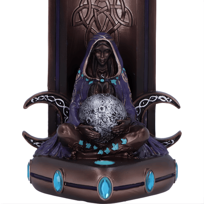 Decorative figurine of a hooded figure holding a crystal ball with intricate designs and blue accents.