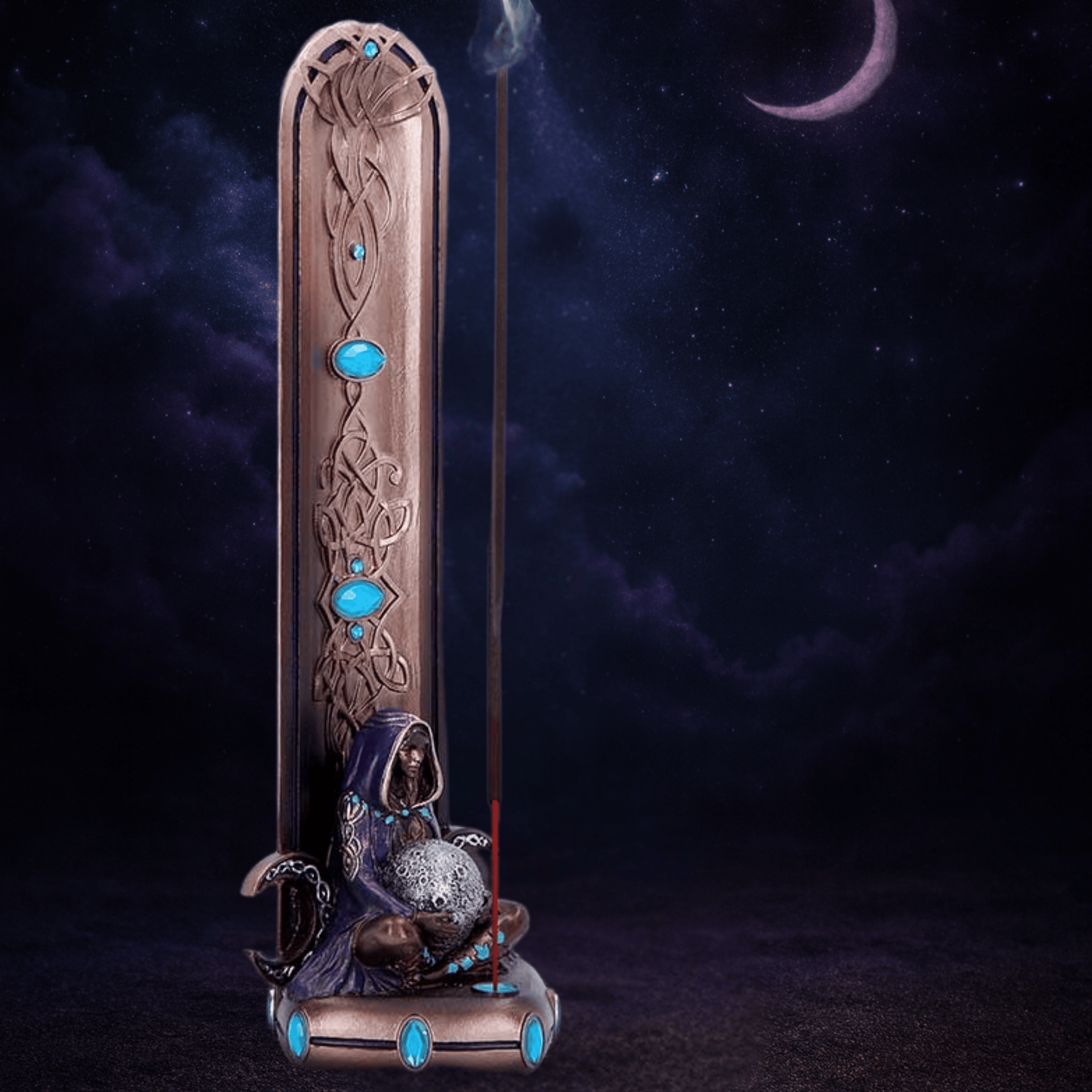 Decorative incense burner with mermaid figure and blue stones against a dark background