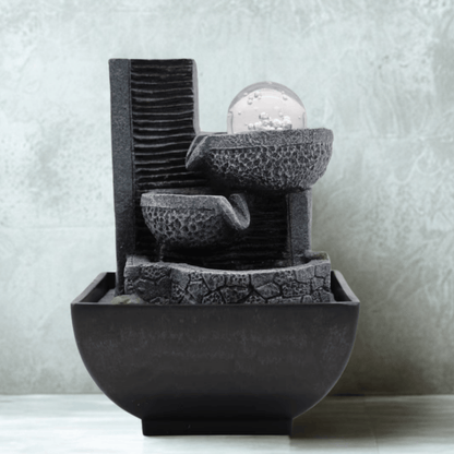 Decorative stone water fountain on a neutral background