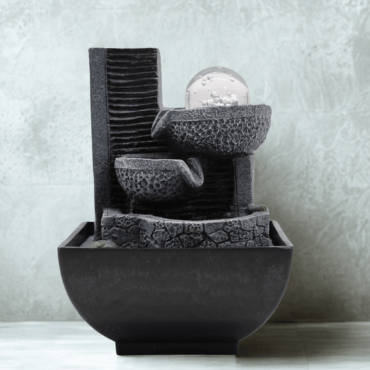 Decorative stone water fountain on a neutral background