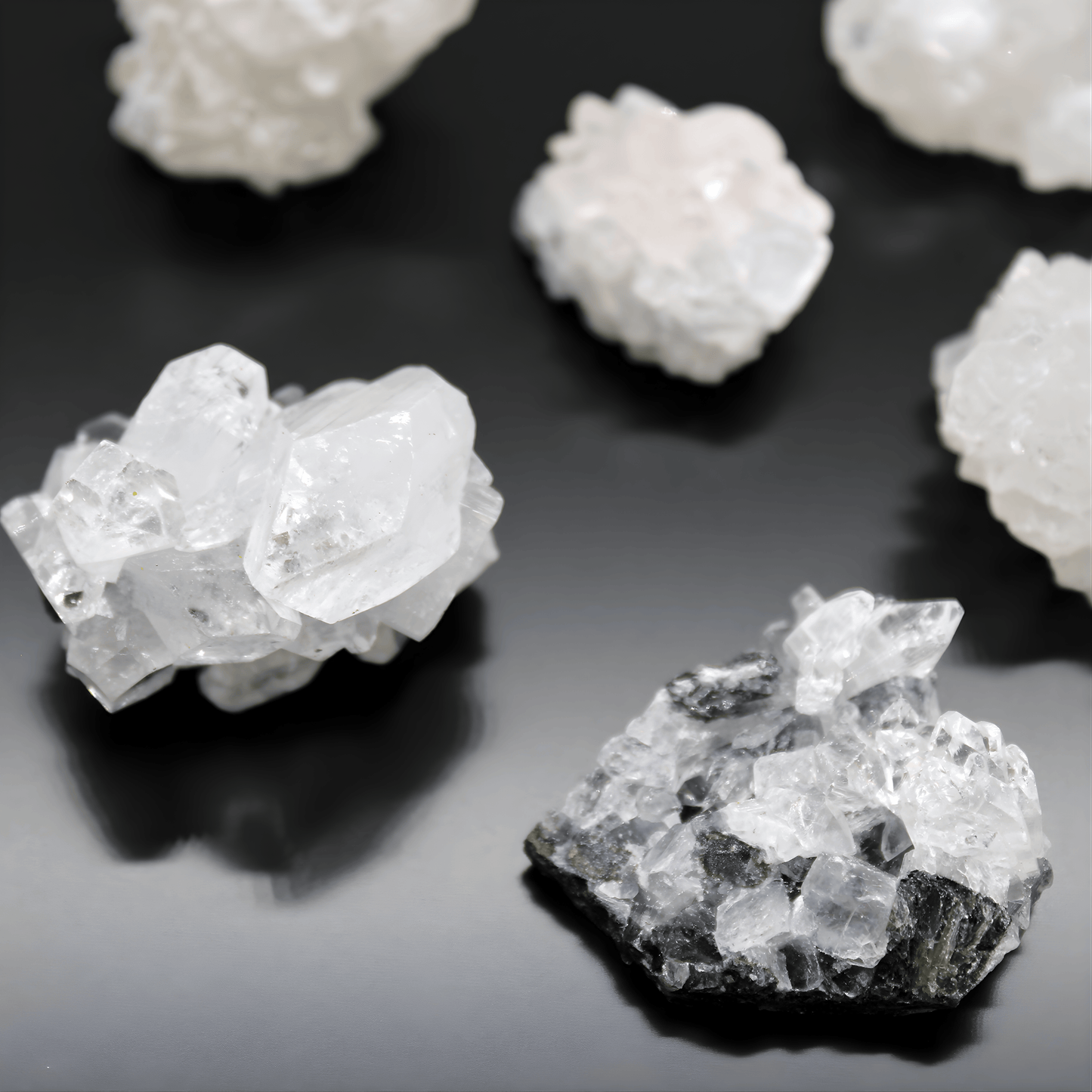 Crystal rock formations on a reflective black surface