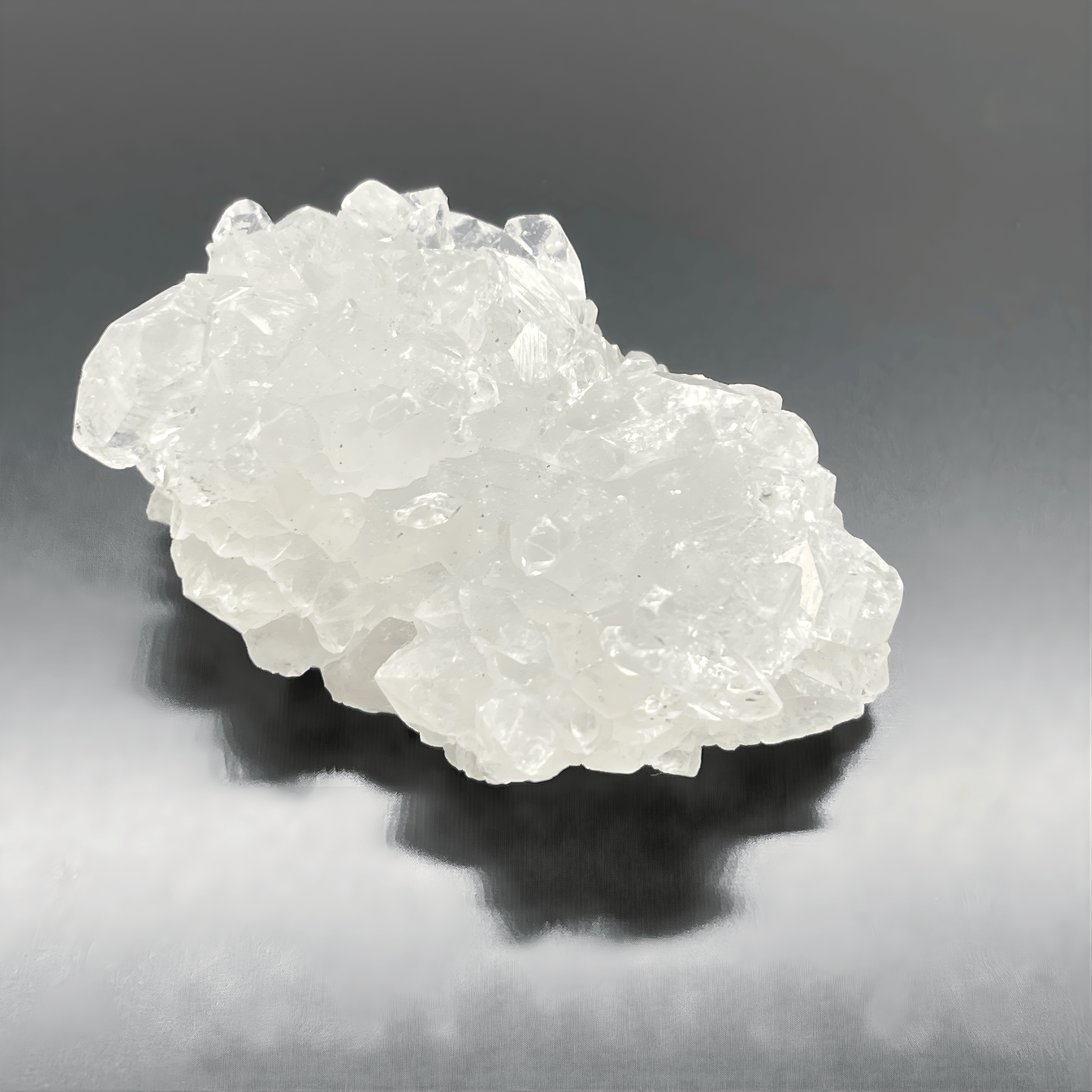 Crystal rock on a reflective gray surface
