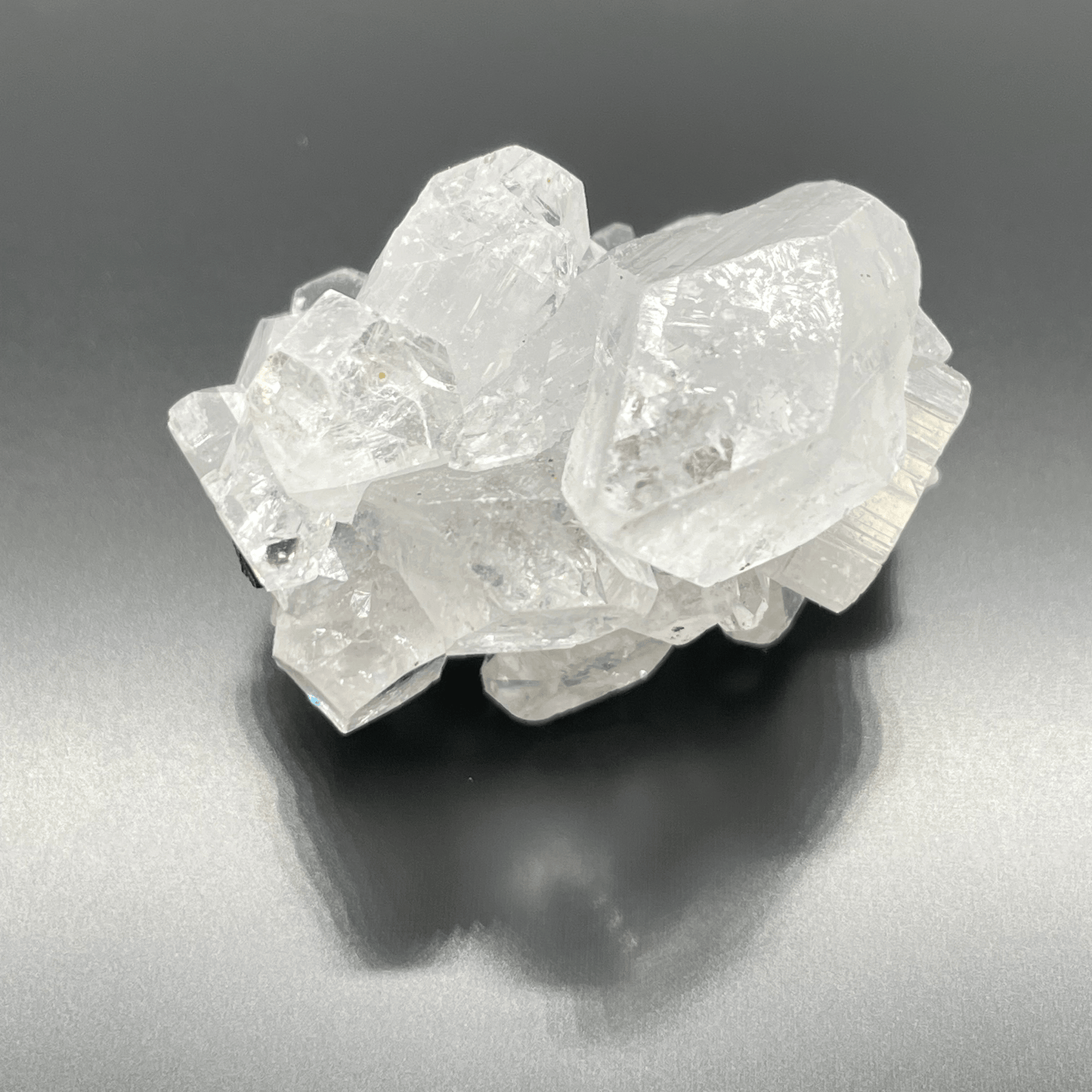 Crystal cluster on a reflective gray surface