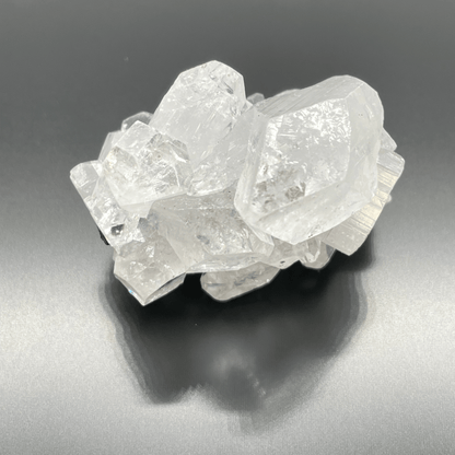 Crystal cluster on a reflective gray surface