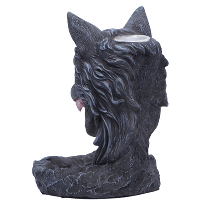 Statue of a wolf head with a candle holder on a white background
