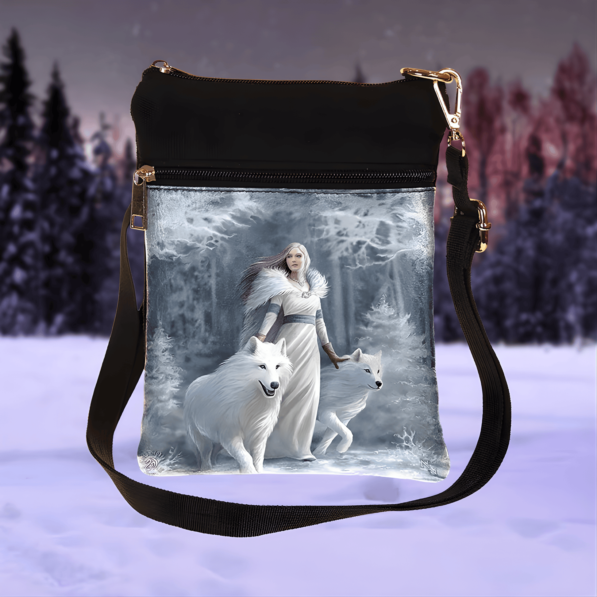 Shoulder bag with a design of a woman and two white wolves in a snowy forest.