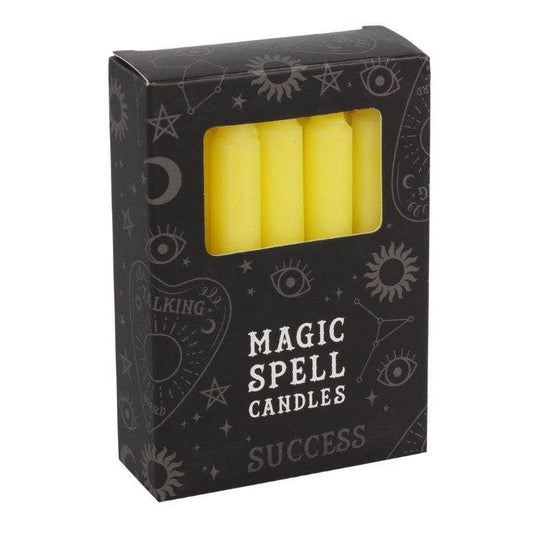 Box of yellow spell candles labeled 'Magic Spell Candles Success' with astrological symbols on a white background.
