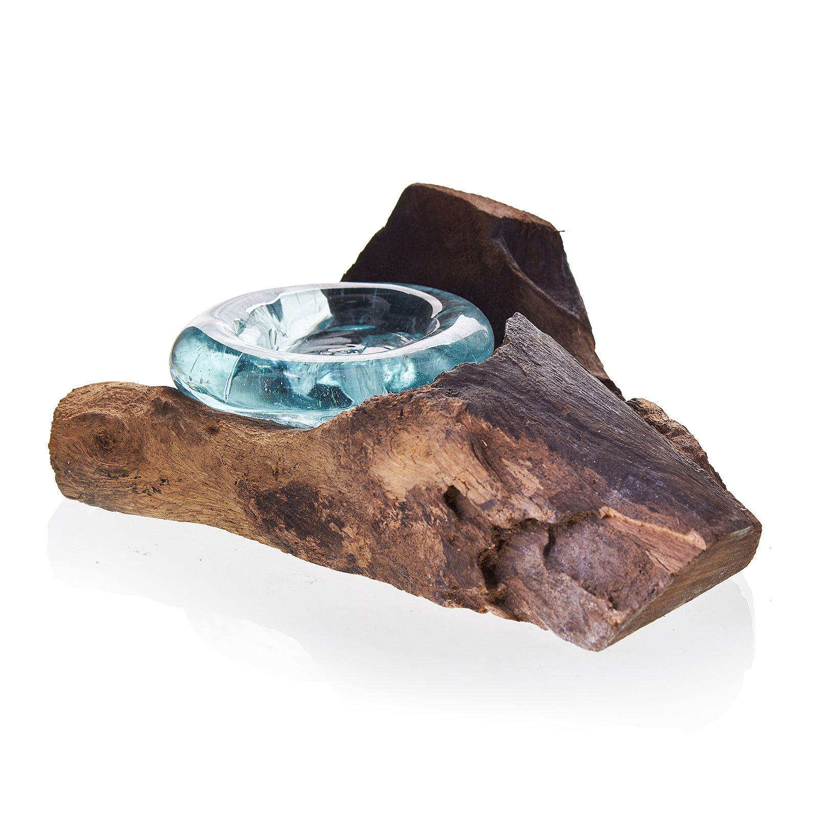 Teal glass bowl on a wooden log against a white background