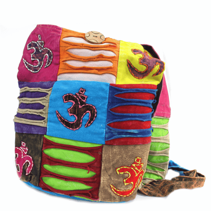 Colorful patchwork bag with embroidered symbols on a white background